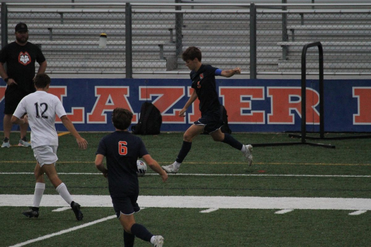 Senior defender George Lewis sets up to boot a ball.