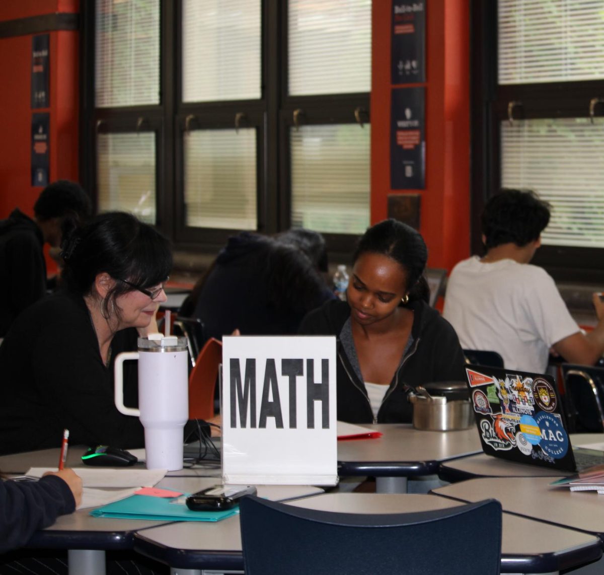 Ms.Brady shown helping Tehtina Tsedeke (12) with math in the Study Center