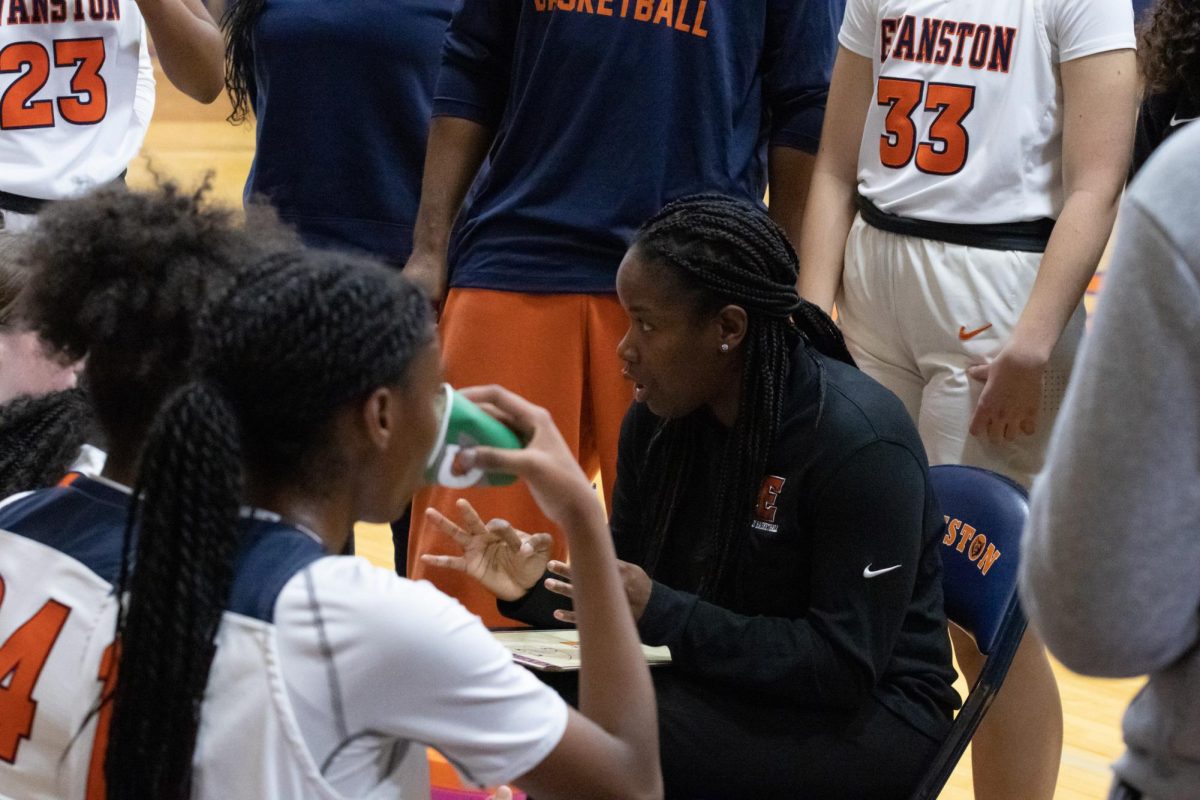 Brittany Johnson coaching the girls basketball team in a timeout