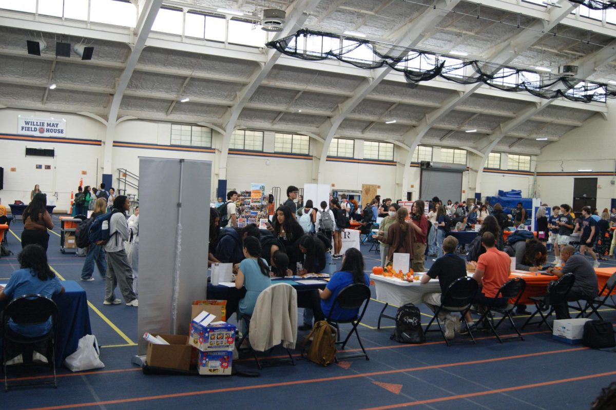 Students walk through the Field House during the Volunteer Fair.  