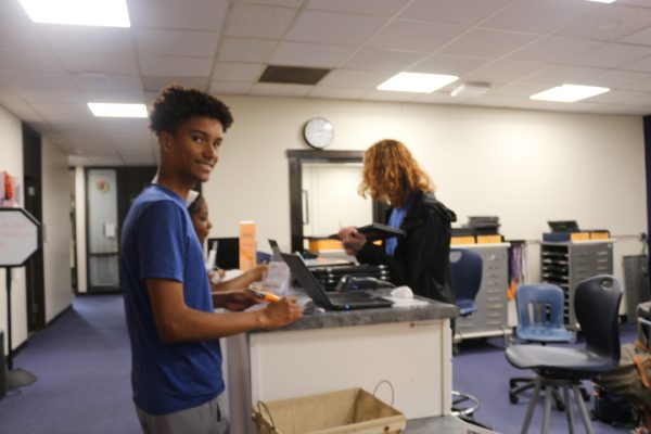 Students in the ChromeZone check out loaner Chromebooks.