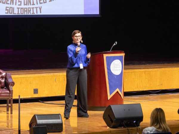 Dr. Kinzie giving a speech in the auditorium.