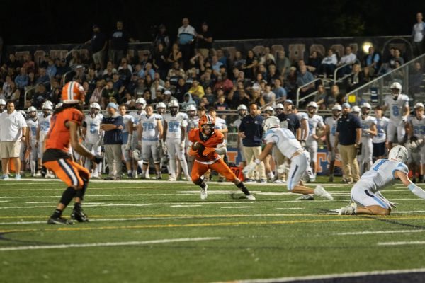 Senior Quarterback Colin Livatino looks to pass to Justin Johnson