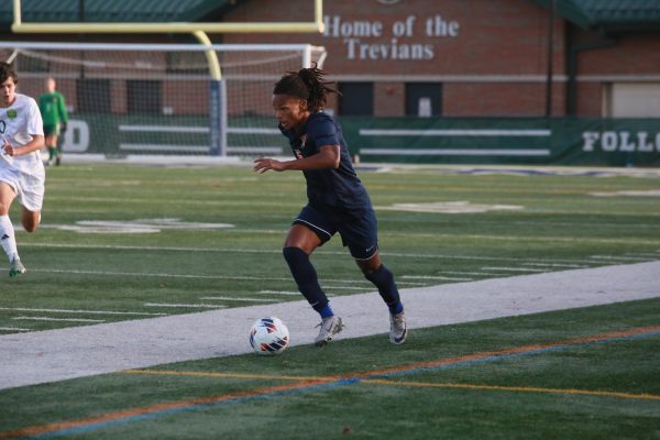 Senior Joseph Sargent drives down sideline