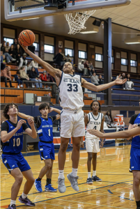 Boys Basketball ends 2024 with conference win against Maine East