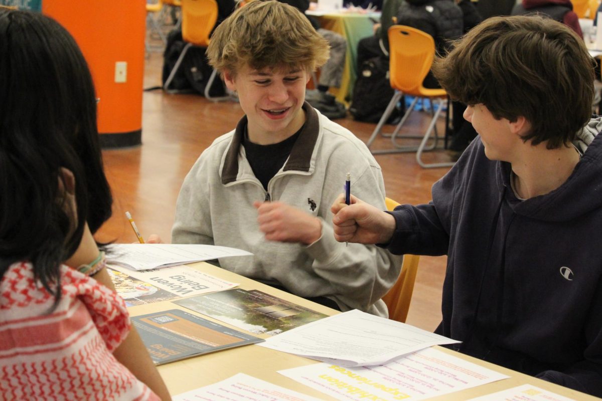 Students speak with local non-profit representatives.