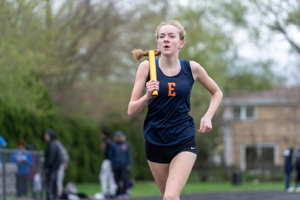 Eliza Hogan running with the baton.